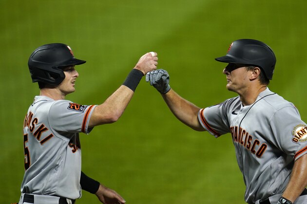 San Francisco Giants' Mike Yastrzemski, left, congratulates Alex Dickerson on Dickerson's three-run home run off Colorado Rockies relief pitcher Jairo Diaz during the sixth inning of a baseball game Tuesday, Sept. 1, 2020, in Denver. (AP Photo/David Zalubowski)