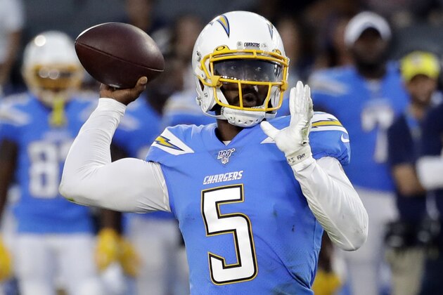 FILE - In this Aug. 25, 2019, file photo, Los Angeles Chargers quarterback Tyrod Taylor throws the ball downfield against the Seattle Seahawks during the first half of an NFL preseason football game in Carson. Philip Rivers started 224 consecutive regular games for the Chargers before leaving to sign with Indianapolis as a free agent. The Chargers now will turn to veteran Tyrod Taylor or first-round rookie Justin Herbert to take over for the reliable Rivers.  (AP Photo/Alex Gallardo, File)