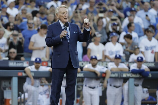 Vin Scully helps throw out the ceremonial first pitch before Game 2 of baseball's World Series between the Houston Astros and the Los Angeles Dodgers Wednesday, Oct. 25, 2017, in Los Angeles. (AP Photo/David J. Phillip) Vin Scully helps throw out the ceremonial first pitch before Game 2 of baseball's World Series between the Houston Astros and the Los Angeles Dodgers Wednesday, Oct. 25, 2017, in Los Angeles. (AP Photo/David J. Phillip)