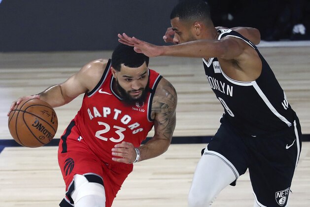 Toronto Raptors guard Fred VanVleet, left,  drives against Brooklyn Nets guard Timothe Luwawu-Cabarrot, right, during the first half of Game 4 of an NBA basketball first-round playoff series, Sunday, Aug. 23, 2020, in Lake Buena Vista, Fla. (Kim Klement/Pool Photo via AP)