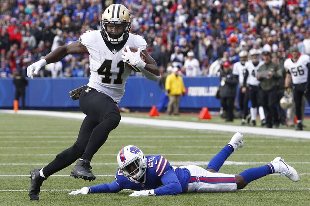 FILE - In this Nov. 12, 2017, file photo, New Orleans Saints running back Alvin Kamara (41) rushes past Buffalo Bills' Shareece Wright (20) during the first half of an NFL football game in Orchard Park, N.Y. Opposing defenses are still having trouble containing Kamara, who leads all rookies in touchdowns. Carolina Panthers coach Ron Rivera says the offense designed by Saints coach Sean Payton is too dynamic to focus on stopping Kamara, which is a factor in the rookie’s success. (AP Photo/Jeffrey T. Barnes, File)