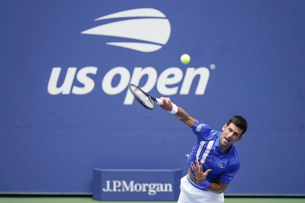 Novak Djokovic, of Serbia, serves to Kyle Edmund, of Great Britain, during the second round of the US Open tennis championships, Wednesday, Sept. 2, 2020, in New York. (AP Photo/Seth Wenig)