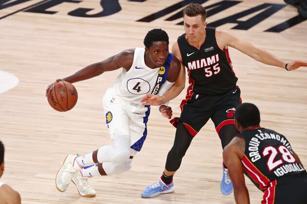 Indiana Pacers guard Victor Oladipo (4) dribbles as Miami Heat guard Duncan Robinson (55) defends during the second half of Game 3 of an NBA basketball first-round playoff series, Saturday, Aug. 22, 2020, in Lake Buena Vista, Fla. (Kim Klement/Pool Photo via AP)
