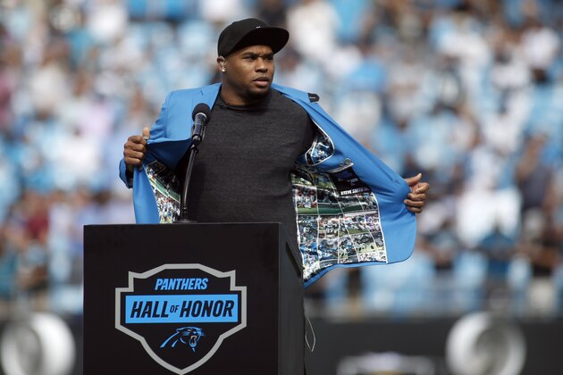 Former Carolina Panthers Steve Smith removes his Hall of Fame jacket during the first half of an NFL football game against the Jacksonville Jaguars in Charlotte, N.C., Sunday, Oct. 6, 2019. (AP Photo/Brian Blanco)
