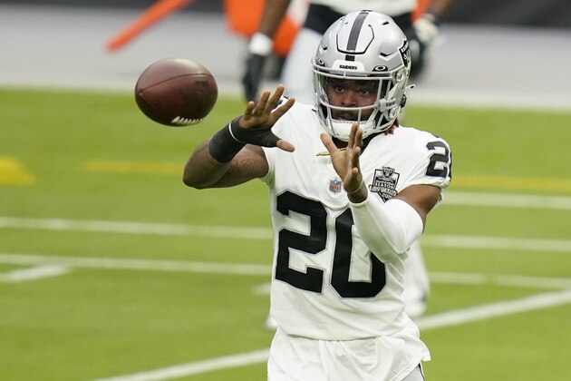Las Vegas Raiders cornerback Damon Arnette (20) catches a ball during an NFL football training camp practice Friday, Aug. 28, 2020, in Las Vegas. (AP Photo/John Locher)