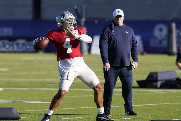 Dallas Cowboys quarterback Dak Prescott (4) works a passing drill as head coach Mike McCarthy looks on during NFL football practice in Frisco, Texas, Thursday, Aug. 20, 2020. (AP Photo/LM Otero)