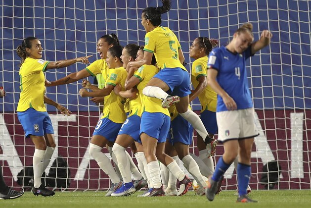 Brazil's Marta, left, celebrates after scoring her side's first goal with a penalty kick during the Women's World Cup Group C soccer match between Italy and Brazil at the Stade du Hainaut in Valenciennes, France, Tuesday, June 18, 2019. (AP Photo/Francisco Seco)