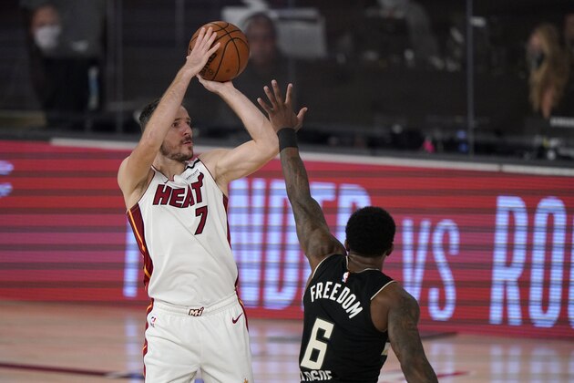 Miami Heat's Goran Dragic (7) shoots over Milwaukee Bucks' Eric Bledsoe (6) during the first half of an NBA conference semifinal playoff basketball game Wednesday, Sept. 2, 2020, in Lake Buena Vista, Fla. (AP Photo/Mark J. Terrill)