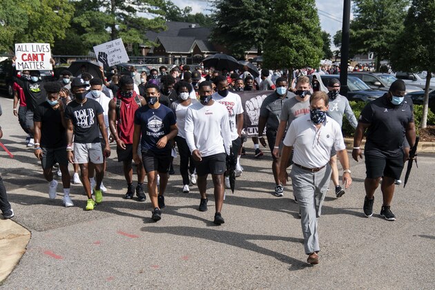 The University of Alabama football team, led by coach Nick Saban, grey slacks, marches on campus supporting the Black Lives Matter movement, Monday, Aug. 31, 2020, in Tuscaloosa, Ala. (AP Photo/Vasha Hunt) The University of Alabama football team, led by coach Nick Saban, grey slacks, marches on campus supporting the Black Lives Matter movement, Monday, Aug. 31, 2020, in Tuscaloosa, Ala. (AP Photo/Vasha Hunt)