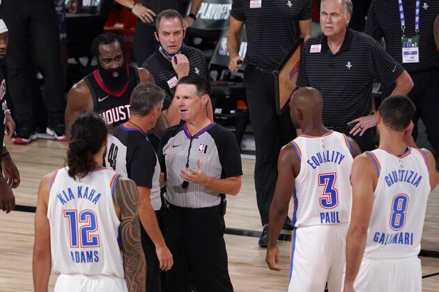 Referees Scott Foster, (48) and Pat Fraher, center right, confer on a foul call against the Houston Rockets as Oklahoma City Thunder's Steven Adams (12), James Harden, left rear, the Thunders' Chris Paul (3), Danilo Gallinari (8) and Rockets head Mike D'Antoni, right rear, look on during the second half of an NBA first-round playoff basketball game in Lake Buena Vista, Fla., Wednesday, Sept. 2, 2020. (AP Photo/Mark J. Terrill) Referees Scott Foster, (48) and Pat Fraher, center right, confer on a foul call against the Houston Rockets as Oklahoma City Thunder's Steven Adams (12), James Harden, left rear, the Thunders' Chris Paul (3), Danilo Gallinari (8) and Rockets head Mike D'Antoni, right rear, look on during the second half of an NBA first-round playoff basketball game in Lake Buena Vista, Fla., Wednesday, Sept. 2, 2020. (AP Photo/Mark J. Terrill)