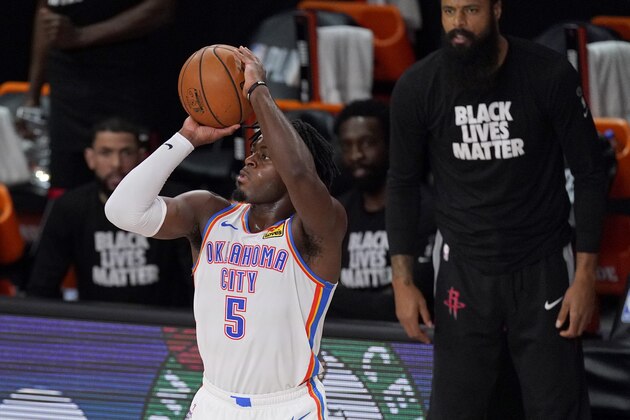 Oklahoma City Thunder's Luguentz Dort (5) goes up for a shot as Tyson Chandler, right rear, looks on during the second half of an NBA first-round playoff basketball game against the Houston Rockets in Lake Buena Vista, Fla., Wednesday, Sept. 2, 2020. (AP Photo/Mark J. Terrill)