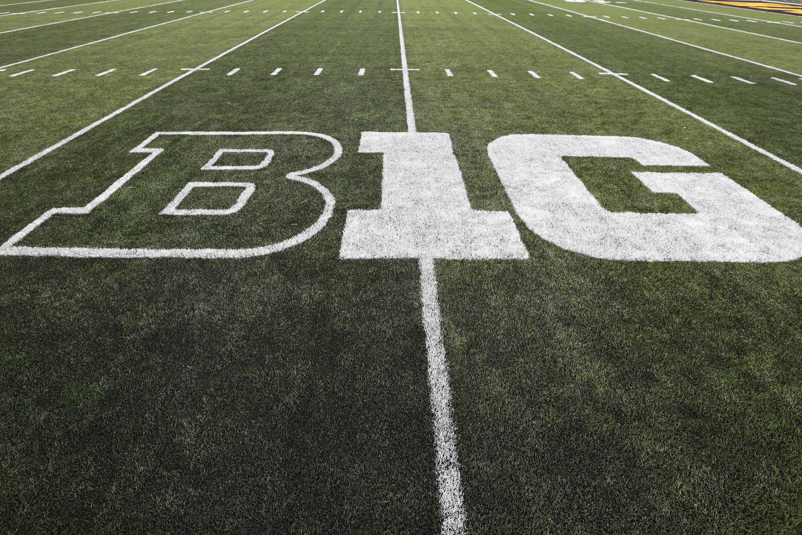FILE - In this Aug. 31, 2019, file photo, the Big Ten logo is displayed on the field before an NCAA college football game between Iowa and Miami of Ohio in Iowa City, Iowa. Big Ten presidents voted 11-3 to postpone the football season until spring, bringing some clarity to a key question raised in a lawsuit brought by a group of Nebraska football players. The vote breakdown was revealed Monday, Aug. 31, 2020, in the Big Ten's court filing in response to the lawsuit. (AP Photo/Charlie Neibergall, File) FILE - In this Aug. 31, 2019, file photo, the Big Ten logo is displayed on the field before an NCAA college football game between Iowa and Miami of Ohio in Iowa City, Iowa. Big Ten presidents voted 11-3 to postpone the football season until spring, bringing some clarity to a key question raised in a lawsuit brought by a group of Nebraska football players. The vote breakdown was revealed Monday, Aug. 31, 2020, in the Big Ten's court filing in response to the lawsuit. (AP Photo/Charlie Neibergall, File)