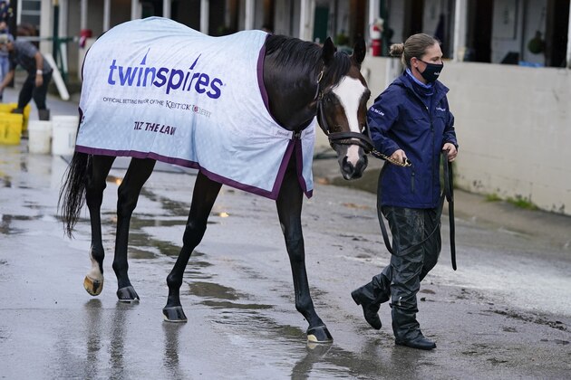 Kentucky Derby entry Tiz the Law is lead back to a stall following a bath at Churchill Downs, Thursday, Sept. 3, 2020, in Louisville, Ky. The Kentucky Derby is scheduled for Saturday, Sept. 5th. (AP Photo/Darron Cummings)