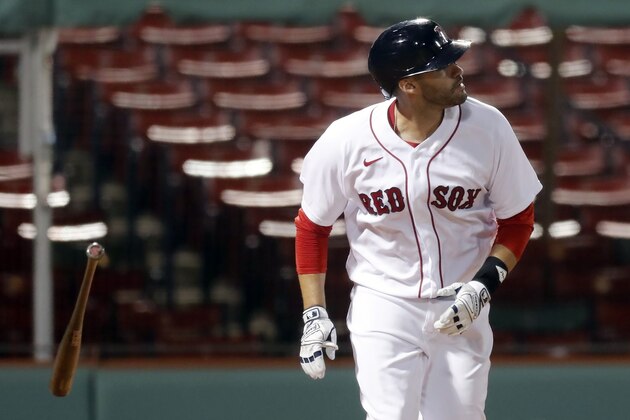 Boston Red Sox's J.D. Martinez watches his solo home run during the third inning of a baseball game against the Tampa Bay Rays, Monday, Aug. 10, 2020, in Boston. (AP Photo/Michael Dwyer)