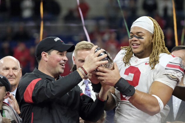 Ohio State coach Ryan Day, left, and defensive end Chase Young (2) hold the trophy following the team's Big Ten championship NCAA college football game against Wisconsin, early Sunday, Dec. 8, 2019, in Indianapolis. Ohio State won 34-21. (AP Photo/AJ Mast)