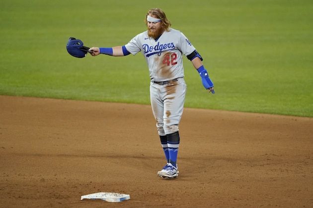 Los Angeles Dodgers' Justin Turner gestures to the dugout after stealing second in the seventh inning of a baseball game against the Texas Rangers in Arlington, Texas, Friday, Aug. 28, 2020. Turner left the game with an unknown injury. (AP Photo/Tony Gutierrez)