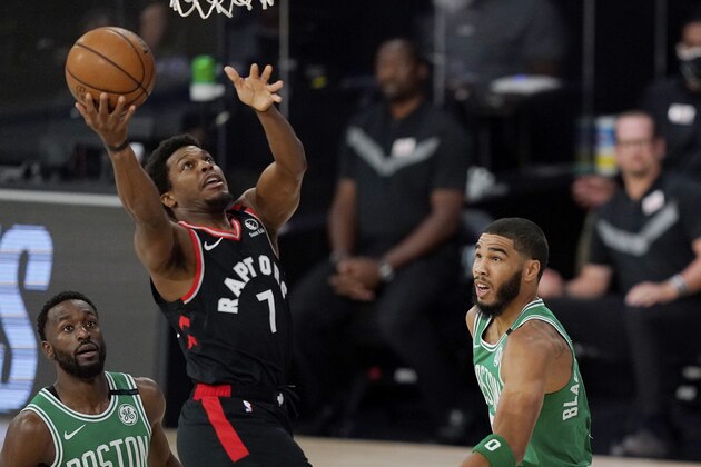 Toronto Raptors' Kyle Lowry (7) shoots between Boston Celtics' Kemba Walker, left, and Boston Celtics' Jayson Tatum, right, in the first half of an NBA conference semifinal playoff basketball game Thursday, Sept 3, 2020, in Lake Buena Vista Fla. (AP Photo/Mark J. Terrill)