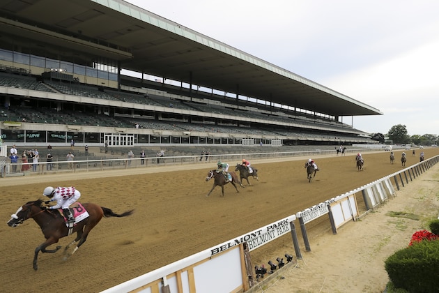 Tiz the Law (8), with jockey Manny Franco up, crosses the finish line in front of an empty grandstand to win the152nd running of the Belmont Stakes horse race, Saturday, June 20, 2020, in Elmont, N.Y. (AP Photo/Seth Wenig)