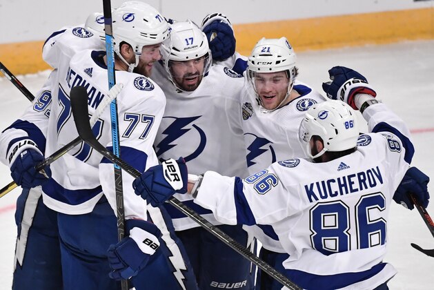 Tampa Bay Lightning's Victor Hedman (77). Alex Killorn (17) and Nikita Kucherov (86) celebrate after an NHL hockey game against the Buffalo Sabres in Globen Arena, Stockholm Sweden. Friday. Nov. 8, 2019. (Anders Wiklund/TT via AP)