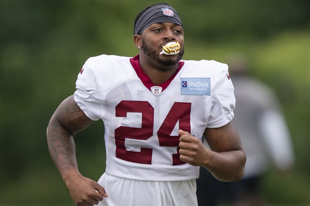 Washington running back Antonio Gibson chews on his mouthpiece during practice at the team's NFL football training facility, Wednesday, Aug. 19, 2020, in Ashburn, Va. (AP Photo/Alex Brandon)