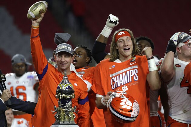 Clemson head coach Dabo Swinney and Trevor Lawrence (16) during the first half of the Fiesta Bowl NCAA college football game against Ohio State, Saturday, Dec. 28, 2019, in Glendale, Ariz. (AP Photo/Rick Scuteri).