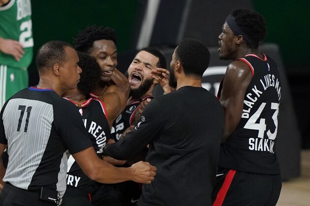 Teammates mob Toronto Raptors' OG Anunoby, second player from left, after Anunoby's game winning shot at the buzzer in the second half of an NBA conference semifinal playoff basketball game against the Boston Celtics Thursday, Sept 3, 2020, in Lake Buena Vista Fla. (AP Photo/Mark J. Terrill)