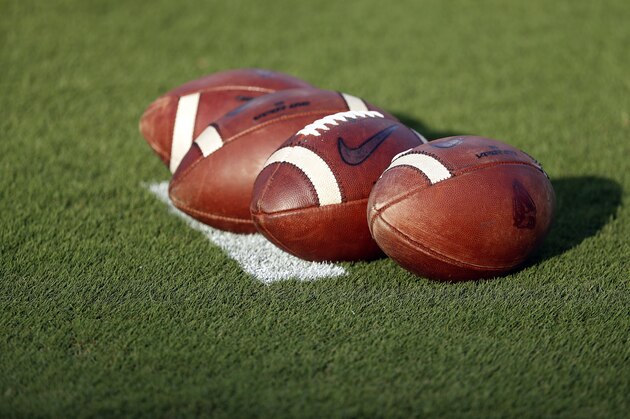 A group of footballs waits for warmups prior to an NCAA college football game between North Carolina State and the Ball State in Raleigh, N.C., Saturday, Sept. 21, 2019. (AP Photo/Karl B DeBlaker)