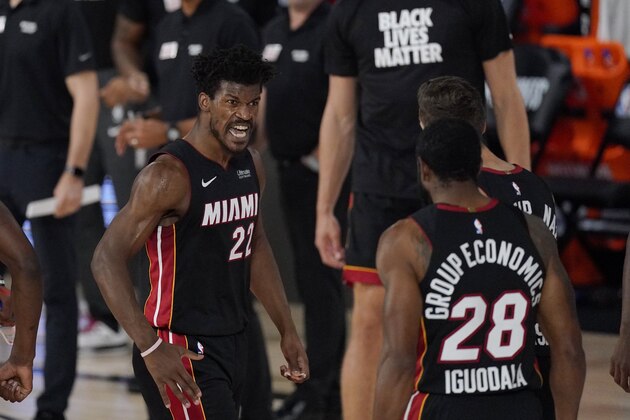 Miami Heat's Jimmy Butler (22) celebrates with teammate Andre Iguodala (28) in the second half of an NBA conference semifinal playoff basketball game against the Milwaukee Bucks Friday, Sept. 4, 2020, in Lake Buena Vista, Fla. (AP Photo/Mark J. Terrill)