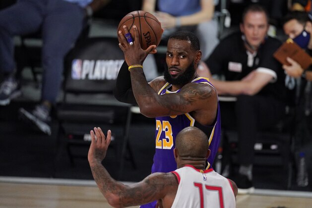 Los Angeles Lakers' LeBron James (23) looks to pass over Houston Rockets' P.J. Tucker (17) during the second half of an NBA conference semifinal playoff basketball game Friday, Sept. 4, 2020, in Lake Buena Vista, Fla. (AP Photo/Mark J. Terrill)