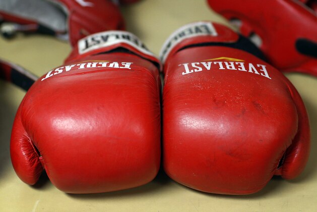 Boxing gloves lay on a table during the Brigade Boxing Championships at the U.S. Naval Academy in Annapolis, Md., Friday, Feb. 28, 2014. The academy has offered boxing since 1865, both as a club sport as well as a required part of the physical education program. (AP Photo/Patrick Semansky)