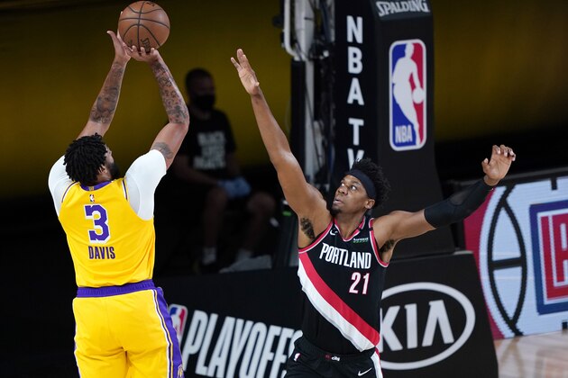 Los Angeles Lakers' Anthony Davis (3) shoots against Portland Trail Blazers' Hassan Whiteside (21) during the first half of an NBA basketball first round playoff game Saturday, Aug. 29, 2020, in Lake Buena Vista, Fla. (AP Photo/Ashley Landis)