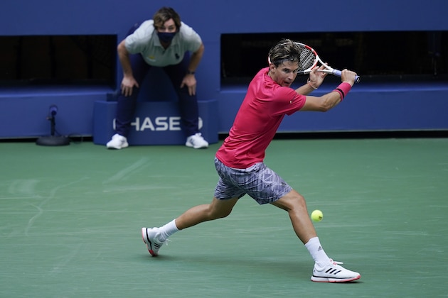 Dominic Thiem, of Austria, returns a shot to Sumit Nagal, of India, during the second round of the US Open tennis championships, Thursday, Sept. 3, 2020, in New York. (AP Photo/Seth Wenig)