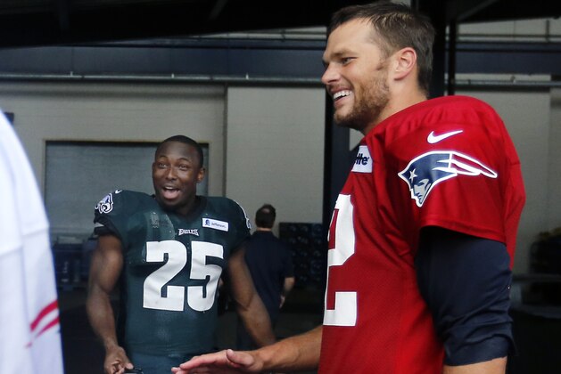 New England Patriots quarterback Tom Brady, right, and Philadelphia Eagles running back LeSean McCoy (25) chat after a joint NFL football training camp practice in Foxborough, Mass., Wednesday, Aug. 13, 2014. (AP Photo/Elise Amendola)