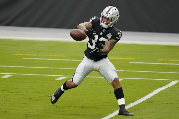 Las Vegas Raiders running back Lynn Bowden Jr. (33) catches a ball during an NFL football training camp practice Friday, Aug. 28, 2020, in Las Vegas. (AP Photo/John Locher)