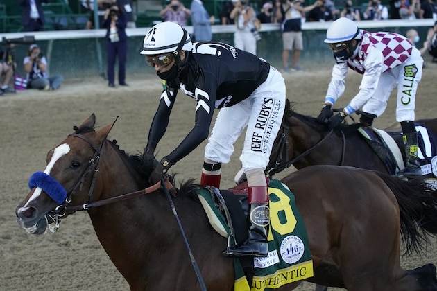 Jockey John Velazquez riding Authentic (18) crosses the finish line ahead of Jockey Manny Franco riding Tiz the Law to win the 146th running of the Kentucky Derby at Churchill Downs, Saturday, Sept. 5, 2020, in Louisville, Ky. (AP Photo/Jeff Roberson)