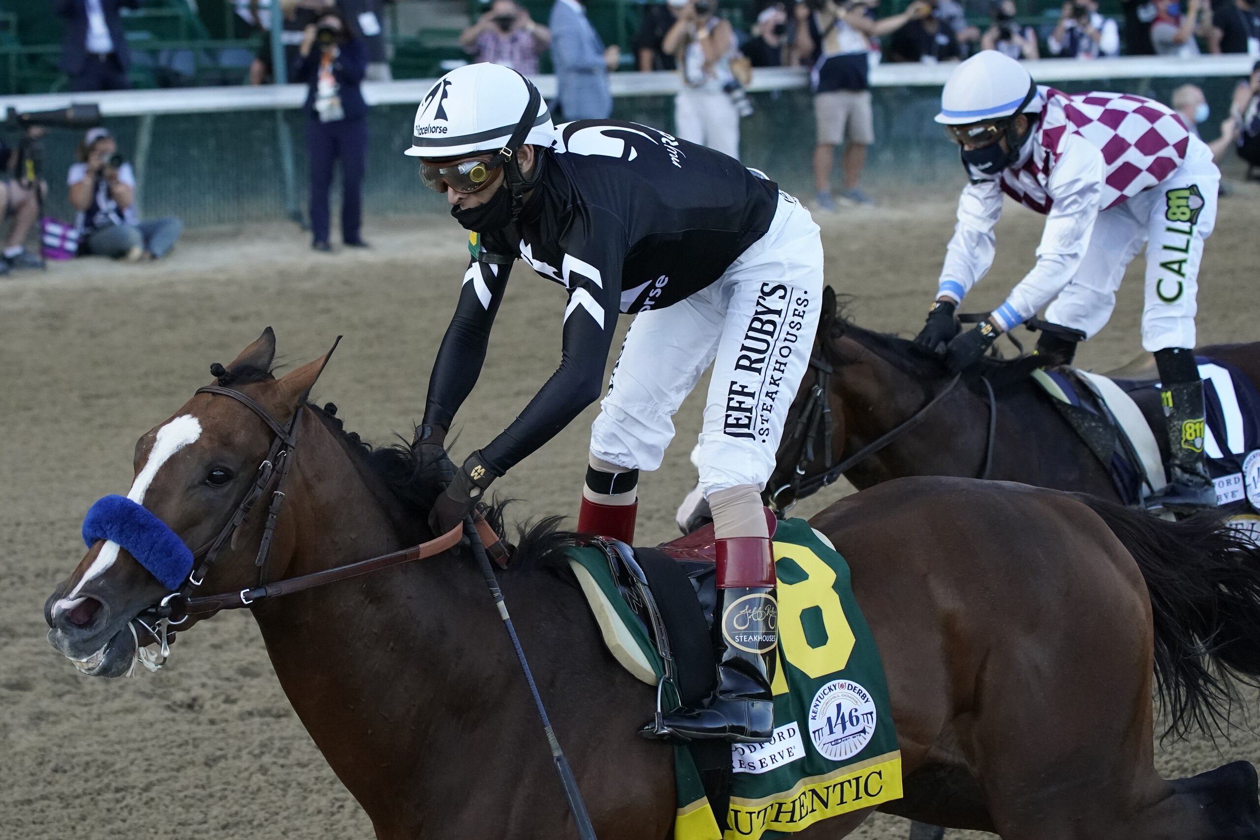 Jockey John Velazquez riding Authentic (18) crosses the finish line ahead of Jockey Manny Franco riding Tiz the Law to win the 146th running of the Kentucky Derby at Churchill Downs, Saturday, Sept. 5, 2020, in Louisville, Ky. (AP Photo/Jeff Roberson) Jockey John Velazquez riding Authentic (18) crosses the finish line ahead of Jockey Manny Franco riding Tiz the Law to win the 146th running of the Kentucky Derby at Churchill Downs, Saturday, Sept. 5, 2020, in Louisville, Ky. (AP Photo/Jeff Roberson)