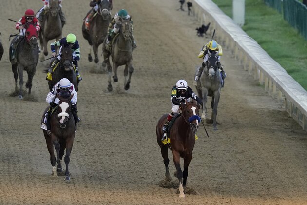 Jockey John Velazquez riding Authentic, second right, heads to the finish line ahead of Jockey Manny Franco riding Tiz the Law to win the 146th running of the Kentucky Derby at Churchill Downs, Saturday, Sept. 5, 2020, in Louisville, Ky. (AP Photo/Charlie Riedel)