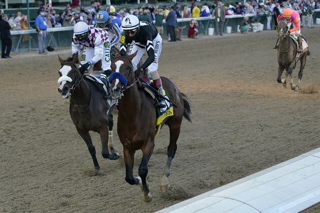 Jockey John Velazquez riding Authentic (18) crosses the finish line ahead of Jockey Manny Franco riding Tiz the Law to win the 146th running of the Kentucky Derby at Churchill Downs, Saturday, Sept. 5, 2020, in Louisville, Ky. (AP Photo/Jeff Roberson)