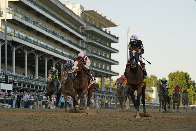 Jockey John Velazquez riding Authentic, right, crosses the finish line to win the 146th running of the Kentucky Derby at Churchill Downs, Saturday, Sept. 5, 2020, in Louisville, Ky. (AP Photo/Jeff Roberson) Jockey John Velazquez riding Authentic, right, crosses the finish line to win the 146th running of the Kentucky Derby at Churchill Downs, Saturday, Sept. 5, 2020, in Louisville, Ky. (AP Photo/Jeff Roberson)