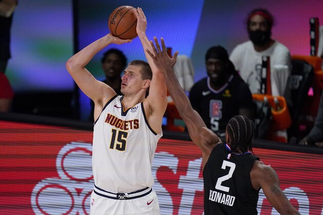 Denver Nuggets' Nikola Jokic (15) shoots in front of Los Angeles Clippers' Kawhi Leonard (2) in the second half of an NBA conference semifinal playoff basketball game Thursday, Sept 3, 2020, in Lake Buena Vista Fla. (AP Photo/Mark J. Terrill) Denver Nuggets' Nikola Jokic (15) shoots in front of Los Angeles Clippers' Kawhi Leonard (2) in the second half of an NBA conference semifinal playoff basketball game Thursday, Sept 3, 2020, in Lake Buena Vista Fla. (AP Photo/Mark J. Terrill)