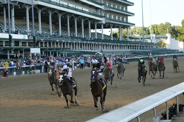 Jockey John Velazquez riding Authentic (18) crosses the finish line ahead of Jockey Manny Franco riding Tiz the Law to win the 146th running of the Kentucky Derby at Churchill Downs, Saturday, Sept. 5, 2020, in Louisville, Ky. (AP Photo/Jeff Roberson)