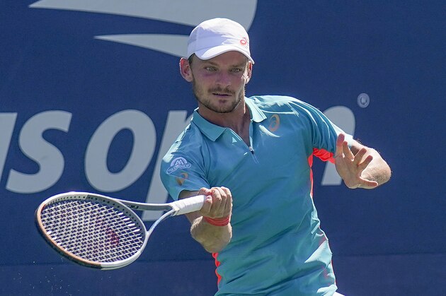 David Goffin, of Belgium, returns a shot to Filip Krajinovic, of Serbia, during the third round of the US Open tennis championships, Friday, Sept. 4, 2020, in New York. (AP Photo/Seth Wenig)