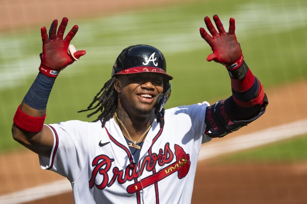 Atlanta Braves' Ronald Acuna Jr. celebrates as he approaches the dugout after a solo home run to center field during the first inning of a double-header baseball game against the Washington Nationals, Friday, Sept. 4, 2020, in Atlanta. (AP Photo/John Amis)