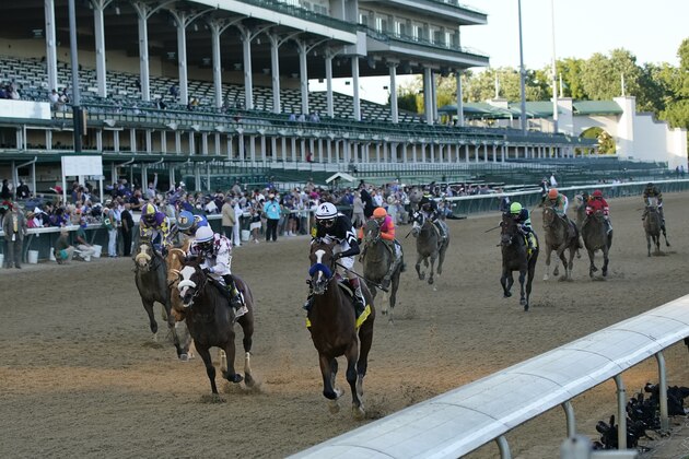 Jockey John Velazquez riding Authentic (18) crosses the finish line ahead of Jockey Manny Franco riding Tiz the Law to win the 146th running of the Kentucky Derby at Churchill Downs, Saturday, Sept. 5, 2020, in Louisville, Ky. (AP Photo/Jeff Roberson)