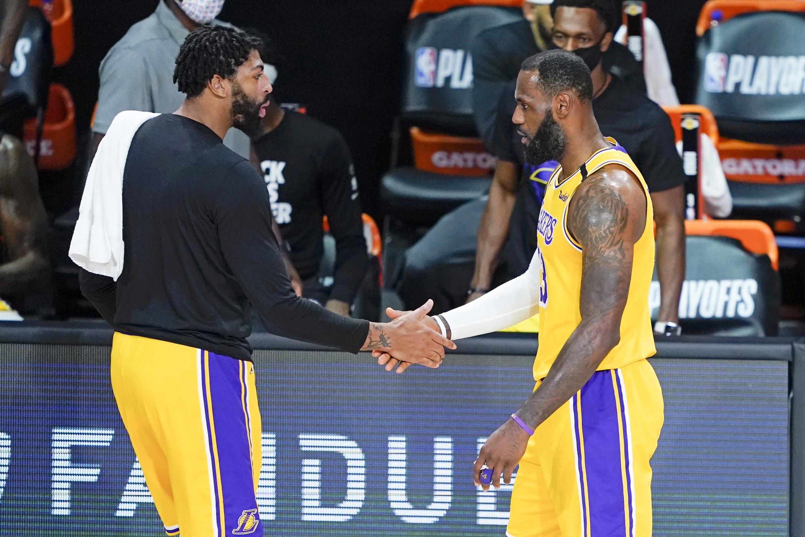 Los Angeles Lakers' Anthony Davis, left, shakes hands with LeBron James as James goes to the bench during the first half of an NBA basketball first round playoff game against the Portland Trail Blazers Saturday, Aug. 29, 2020, in Lake Buena Vista, Fla. (AP Photo/Ashley Landis) Los Angeles Lakers' Anthony Davis, left, shakes hands with LeBron James as James goes to the bench during the first half of an NBA basketball first round playoff game against the Portland Trail Blazers Saturday, Aug. 29, 2020, in Lake Buena Vista, Fla. (AP Photo/Ashley Landis)