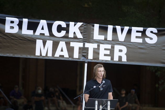 FILE - Clemson quarterback Trevor Lawrence speaks during a protest over the death of George Floyd Saturday, June 13, 2020, in Clemson, S.C. This summer college athletes have organized campus marches, threatened boycotts, and been trending on social media as if they had just scored game-winning touchdowns without stepping foot on a field. (AP Photo/John Bazemore)