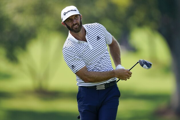 Dustin Johnson watches his tee shot on the fourth hole during the third round of the Tour Championship golf tournament at East Lake Golf Club in Atlanta, Sunday, Sept. 6, 2020. (AP Photo/John Bazemore)