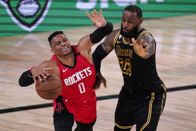 Houston Rockets' Russell Westbrook (0) drives against Los Angeles Lakers' LeBron James (23) during the second half of an NBA conference semifinal playoff basketball game Sunday, Sept. 6, 2020, in Lake Buena Vista, Fla. (AP Photo/Mark J. Terrill)
