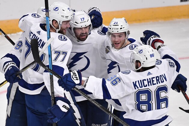Tampa Bay Lightning's Victor Hedman (77). Alex Killorn (17) and Nikita Kucherov (86) celebrate after an NHL hockey game against the Buffalo Sabres in Globen Arena, Stockholm Sweden. Friday. Nov. 8, 2019. (Anders Wiklund/TT via AP)
