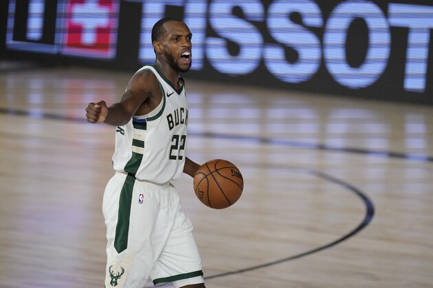 Milwaukee Bucks' Khris Middleton (22) directs his team in the second half of an NBA conference semifinal playoff basketball game against the Miami Heat Friday, Sept. 4, 2020, in Lake Buena Vista, Fla. (AP Photo/Mark J. Terrill)
